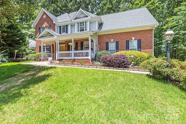 171 Highland Woods Ct, Denver, NC 28037 - view of front of house featuring brick siding, a porch, a front yard, and a shingled roof