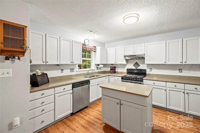 171 Highland Woods Ct, Denver, NC 28037 - kitchen with stainless steel dishwasher, gas range oven, under cabinet range hood, decorative backsplash, and a textured ceiling