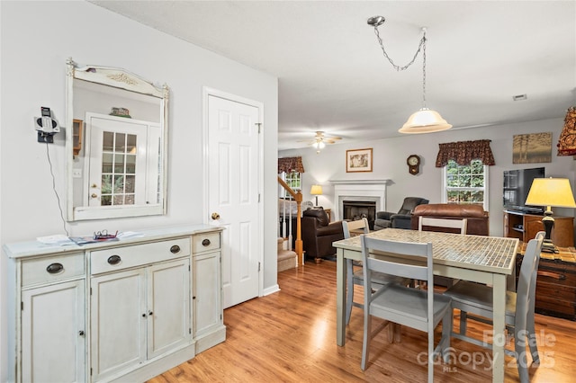 171 Highland Woods Ct, Denver, NC 28037 - dining room featuring light wood-type flooring, a fireplace, and ceiling fan