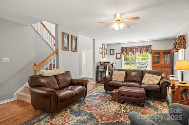 171 Highland Woods Ct, Denver, NC 28037 - living room with wood finished floors, stairway, a ceiling fan, and a textured ceiling