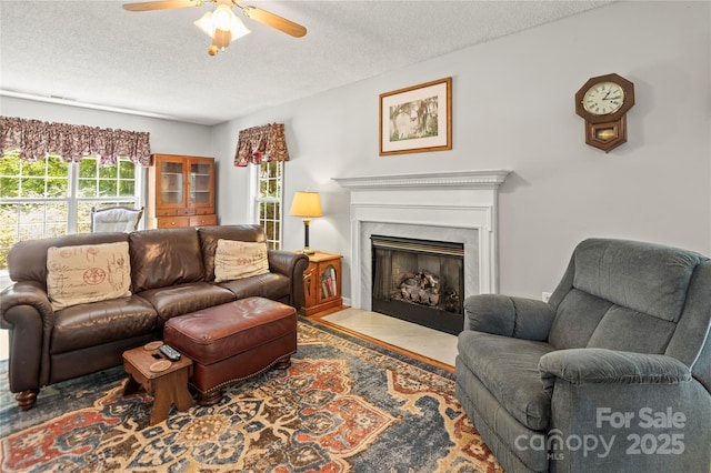 171 Highland Woods Ct, Denver, NC 28037 - living area featuring a textured ceiling, a ceiling fan, a premium fireplace, and wood finished floors