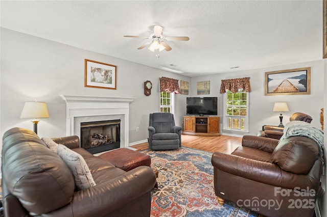 171 Highland Woods Ct, Denver, NC 28037 - living room with a ceiling fan, wood finished floors, a high end fireplace, and a textured ceiling