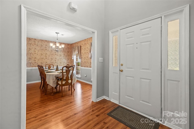 171 Highland Woods Ct, Denver, NC 28037 - foyer entrance featuring wallpapered walls, a chandelier, wood finished floors, and wainscoting
