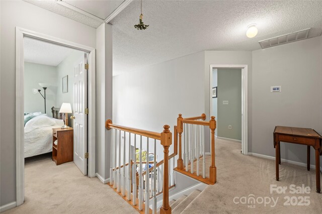 171 Highland Woods Ct, Denver, NC 28037 - corridor featuring carpet flooring, an upstairs landing, a textured ceiling, and attic access