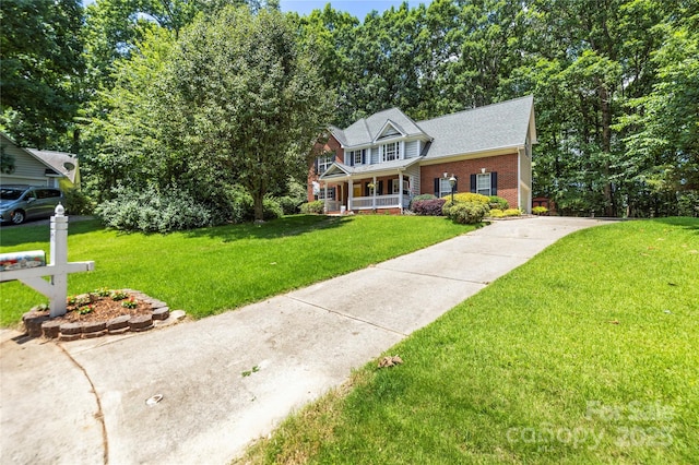 171 Highland Woods Ct, Denver, NC 28037 - view of front facade with covered porch, brick siding, a front lawn, and roof with shingles