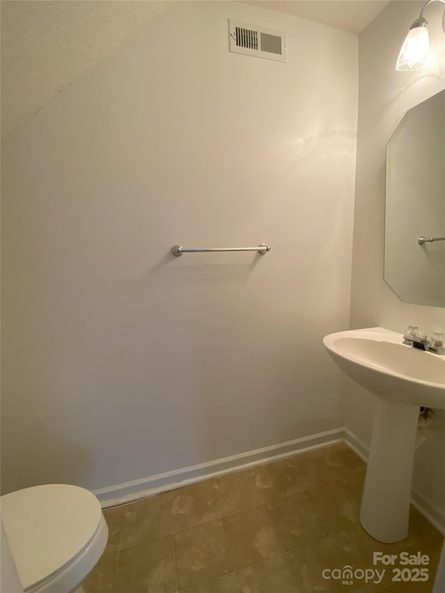 3933 Cameron Creek Dr, Matthews, NC 28105 - half bath with tile patterned flooring and vaulted ceiling