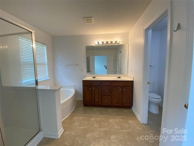 3933 Cameron Creek Dr, Matthews, NC 28105 - bathroom with a garden tub, double vanity, a shower stall, and a textured ceiling