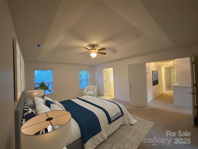3933 Cameron Creek Dr, Matthews, NC 28105 - bedroom featuring light colored carpet, a ceiling fan, and a raised ceiling