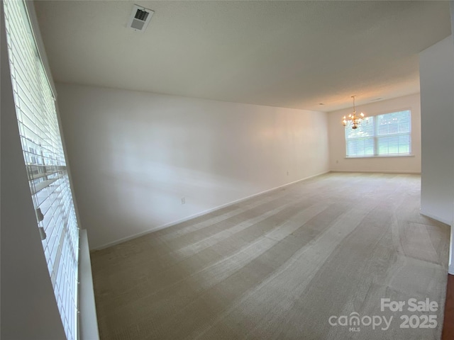 3933 Cameron Creek Dr, Matthews, NC 28105 - spare room featuring a chandelier and light colored carpet