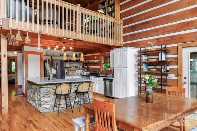 1745 Sugar Camp Rd, Marshall, NC 28753 - dining room featuring light wood-style flooring and wooden walls