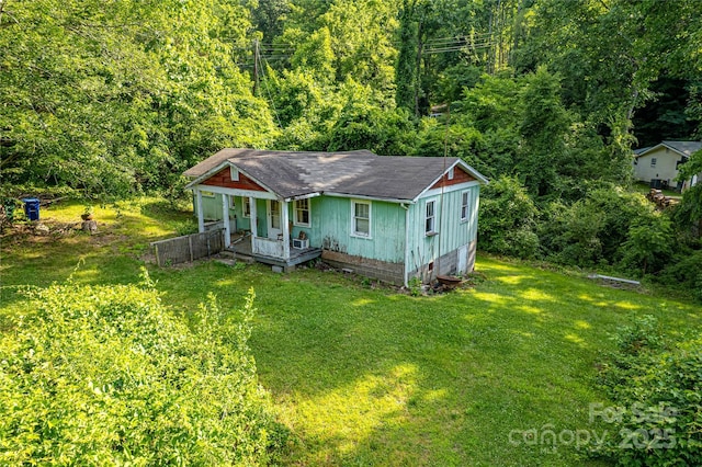 121 Sugar Cove Rd, Weaverville, NC 28787 - bungalow with a front lawn, a shingled roof, a view of trees, and covered porch
