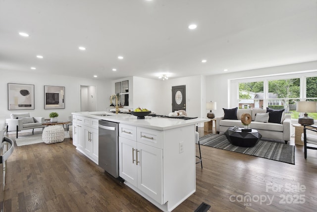 5817 Red Carriage Ln, Charlotte, NC 28212 - kitchen featuring stainless steel dishwasher, open floor plan, a center island with sink, recessed lighting, and dark wood-style flooring