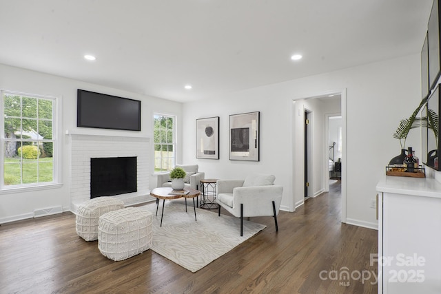 5817 Red Carriage Ln, Charlotte, NC 28212 - living area with dark wood finished floors, plenty of natural light, recessed lighting, and a brick fireplace