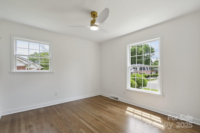 5817 Red Carriage Ln, Charlotte, NC 28212 - empty room with healthy amount of natural light, a ceiling fan, and wood finished floors