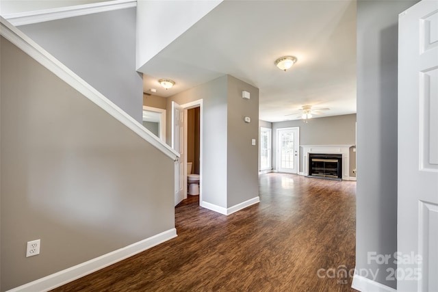 12812 Bradford Hill Ln, Huntersville, NC 28078 - unfurnished living room featuring ceiling fan, dark wood-style flooring, and a glass covered fireplace