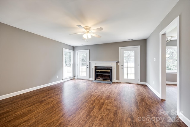 12812 Bradford Hill Ln, Huntersville, NC 28078 - unfurnished living room featuring a ceiling fan, dark wood finished floors, and a glass covered fireplace