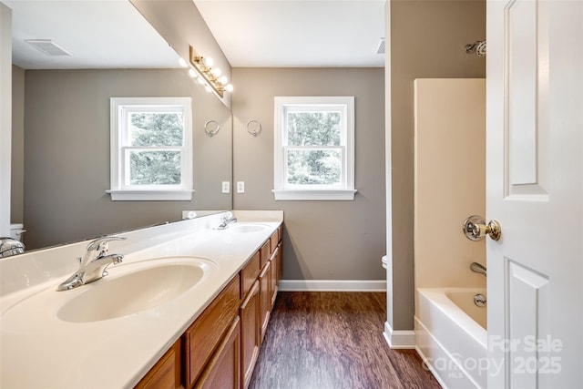 12812 Bradford Hill Ln, Huntersville, NC 28078 - bathroom featuring double vanity, wood finished floors, and bathing tub / shower combination