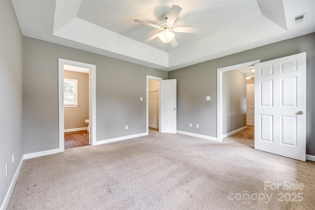 12812 Bradford Hill Ln, Huntersville, NC 28078 - unfurnished bedroom featuring a tray ceiling, carpet floors, ensuite bath, a spacious closet, and a ceiling fan