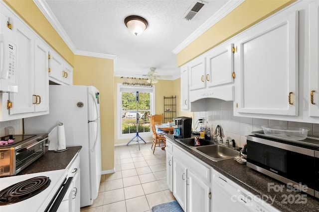 1670 Robins Nest Ct Unit C, Gastonia, NC 28054 - kitchen with white appliances, ceiling fan, dark countertops, white cabinetry, and crown molding