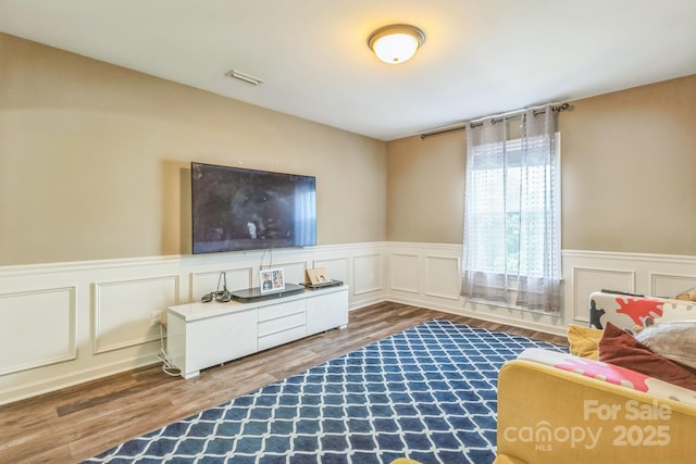 2100 Darian Way, Waxhaw, NC 28173 - living room with wood finished floors, a decorative wall, and wainscoting