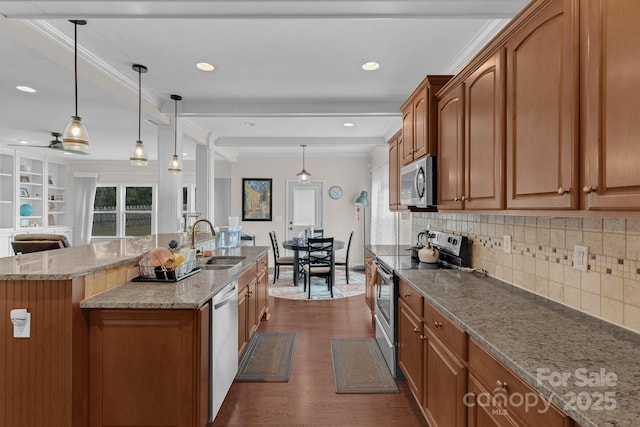 2100 Darian Way, Waxhaw, NC 28173 - kitchen with appliances with stainless steel finishes, brown cabinets, dark wood-style floors, tasteful backsplash, and recessed lighting