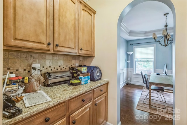 2100 Darian Way, Waxhaw, NC 28173 - kitchen featuring crown molding, a chandelier, arched walkways, dark wood finished floors, and backsplash