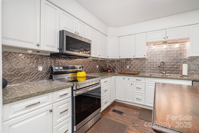 4725 Rounding Run Rd, Charlotte, NC 28277 - kitchen with stainless steel appliances, dark wood-style flooring, white cabinets, and tasteful backsplash