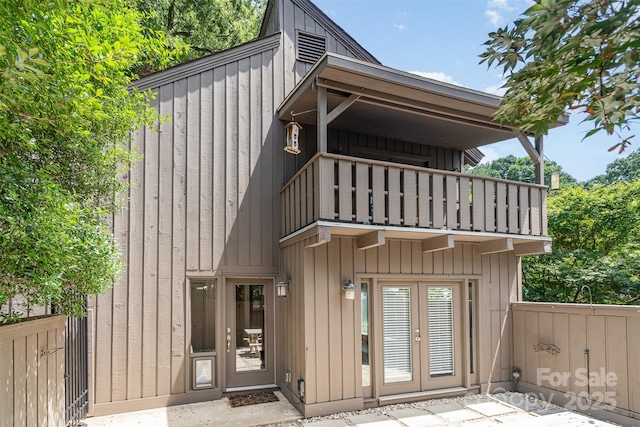 4725 Rounding Run Rd, Charlotte, NC 28277 - rear view of house featuring a balcony, board and batten siding, and french doors