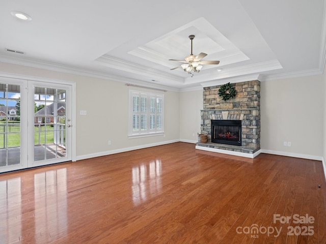 2872 Wheat Field Ct, Lincolnton, NC 28092 - unfurnished living room with a tray ceiling, healthy amount of natural light, a stone fireplace, and crown molding