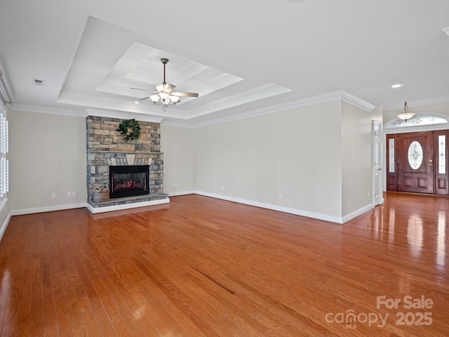 2872 Wheat Field Ct, Lincolnton, NC 28092 - unfurnished living room with a raised ceiling, a ceiling fan, wood finished floors, a fireplace, and crown molding