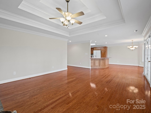 2872 Wheat Field Ct, Lincolnton, NC 28092 - unfurnished living room with a tray ceiling, crown molding, wood finished floors, a chandelier, and a ceiling fan