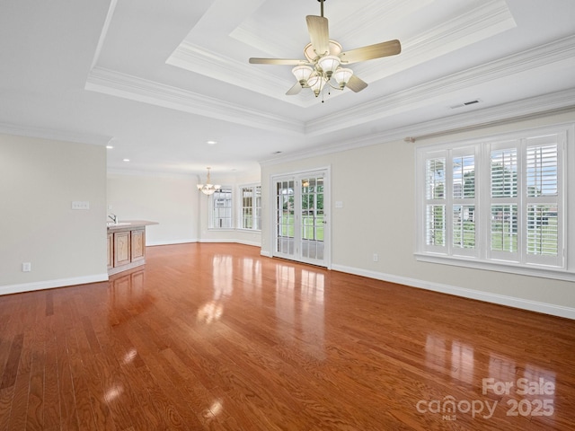 2872 Wheat Field Ct, Lincolnton, NC 28092 - unfurnished living room with a chandelier, a raised ceiling, crown molding, wood finished floors, and ceiling fan