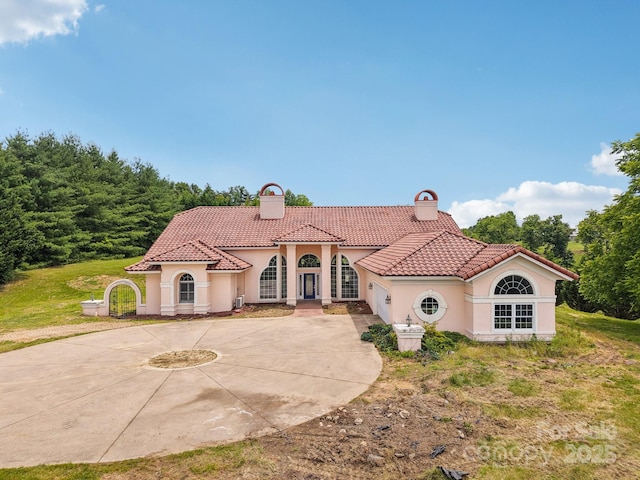 69 Sprouse Town Rd, Weaverville, NC 28787 - mediterranean / spanish-style house with a chimney, curved driveway, stucco siding, a tiled roof, and french doors