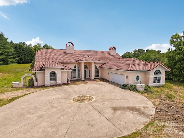 69 Sprouse Town Rd, Weaverville, NC 28787 - mediterranean / spanish-style house featuring a chimney, a tile roof, stucco siding, and concrete driveway