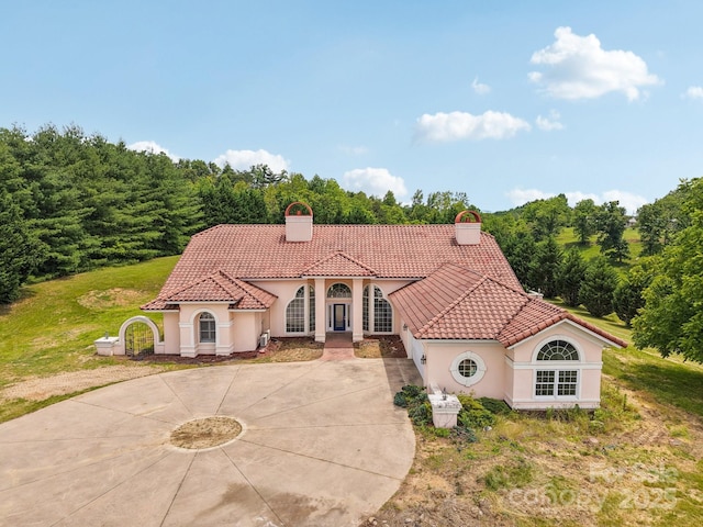 69 Sprouse Town Rd, Weaverville, NC 28787 - mediterranean / spanish home with a chimney, curved driveway, a tile roof, and stucco siding