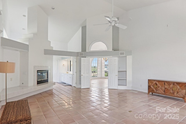 69 Sprouse Town Rd, Weaverville, NC 28787 - unfurnished living room with high vaulted ceiling, a fireplace, ceiling fan, and tile patterned flooring
