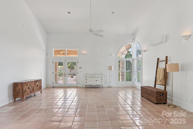 69 Sprouse Town Rd, Weaverville, NC 28787 - unfurnished living room featuring ceiling fan, healthy amount of natural light, tile patterned flooring, and a wall mounted air conditioner
