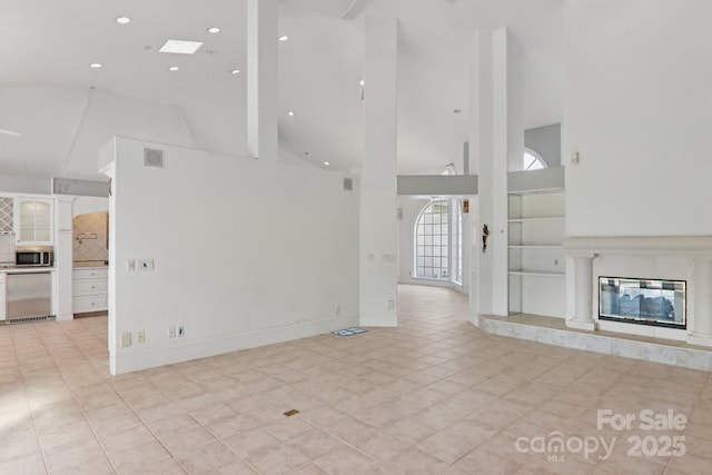 69 Sprouse Town Rd, Weaverville, NC 28787 - unfurnished living room featuring high vaulted ceiling, light tile patterned floors, a fireplace, and recessed lighting