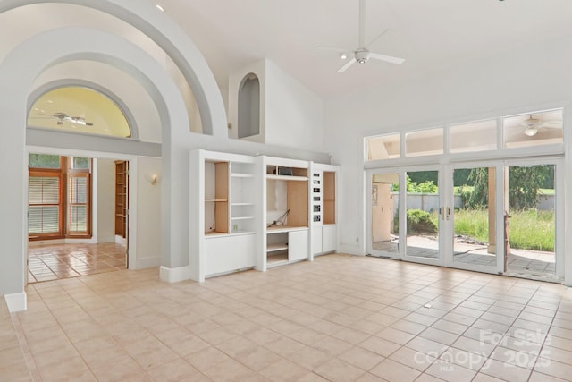 69 Sprouse Town Rd, Weaverville, NC 28787 - unfurnished living room featuring a ceiling fan, high vaulted ceiling, light tile patterned floors, and french doors