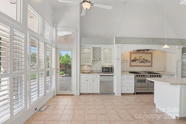 69 Sprouse Town Rd, Weaverville, NC 28787 - kitchen featuring stainless steel appliances, healthy amount of natural light, tasteful backsplash, and high vaulted ceiling