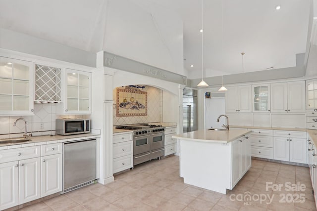 69 Sprouse Town Rd, Weaverville, NC 28787 - kitchen with stainless steel appliances, tasteful backsplash, vaulted ceiling, light countertops, and white cabinets