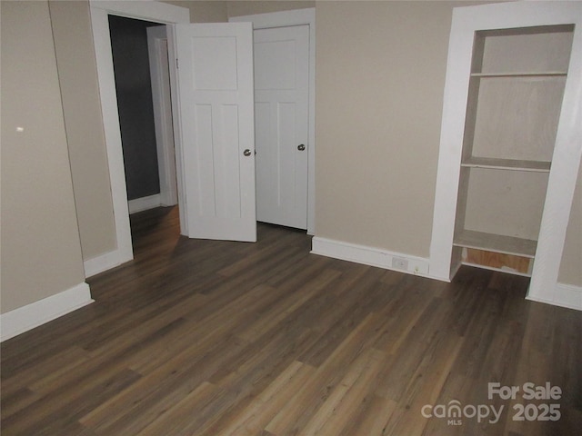 1110 20th St NE, Hickory, NC 28601 - unfurnished bedroom featuring dark wood-type flooring and baseboards