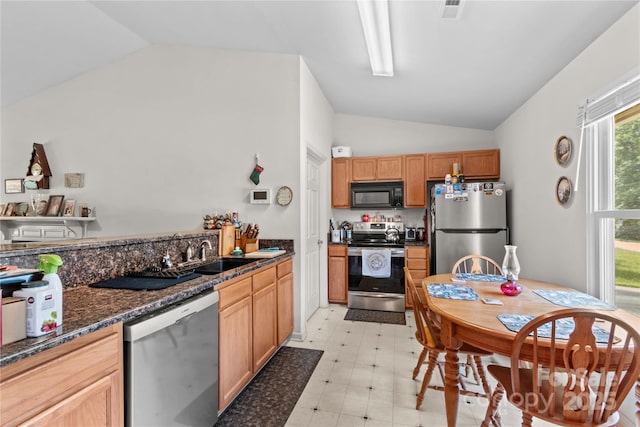 428 Mountview Dr, Mocksville, NC 27028 - kitchen with appliances with stainless steel finishes, lofted ceiling, light floors, and dark stone countertops