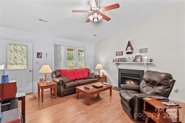428 Mountview Dr, Mocksville, NC 27028 - living area with light wood-type flooring, a ceiling fan, lofted ceiling, and a fireplace with flush hearth