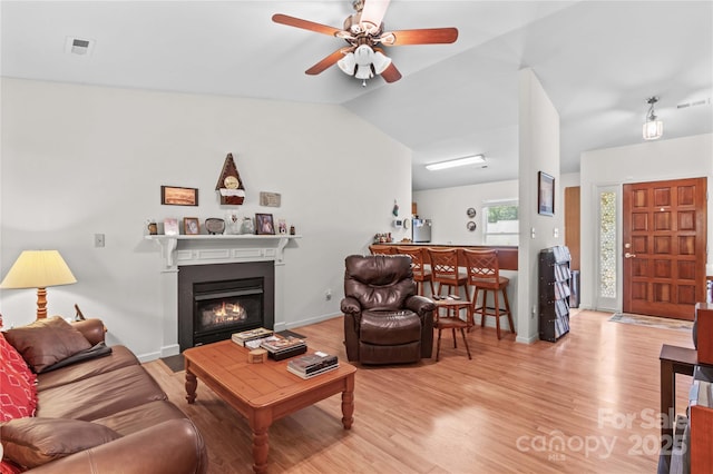 428 Mountview Dr, Mocksville, NC 27028 - living area with ceiling fan, wood finished floors, a glass covered fireplace, and vaulted ceiling