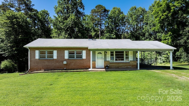 917 Sunset Ave SW, Valdese, NC 28690 - view of front facade featuring a front lawn, an attached carport, brick siding, and covered porch