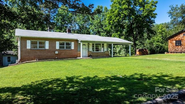 917 Sunset Ave SW, Valdese, NC 28690 - ranch-style house with a front yard, brick siding, and a shed