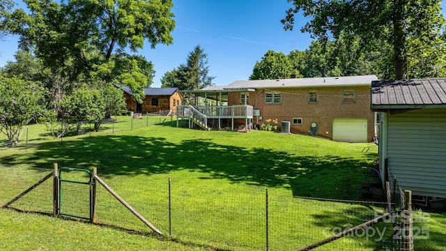 917 Sunset Ave SW, Valdese, NC 28690 - view of yard featuring an attached garage, a deck, and stairs
