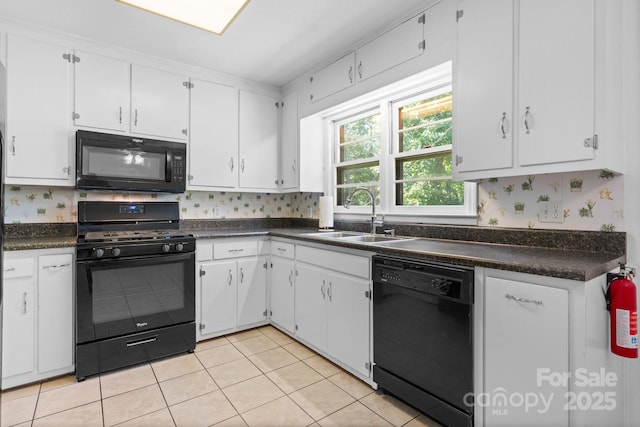 917 Sunset Ave SW, Valdese, NC 28690 - kitchen with black appliances, dark countertops, white cabinetry, and light tile patterned flooring