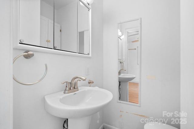 917 Sunset Ave SW, Valdese, NC 28690 - half bath featuring a sink and baseboards
